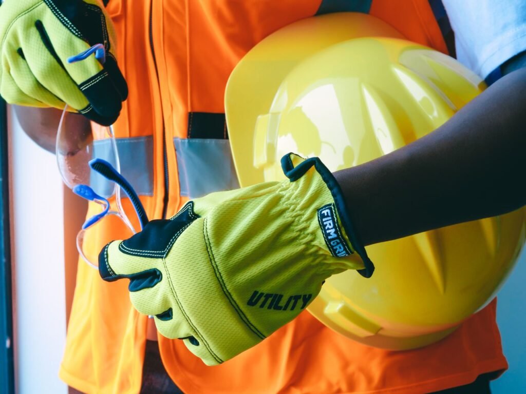 Close-up of personal protective equipment including gloves and helmet, essential for safety.
